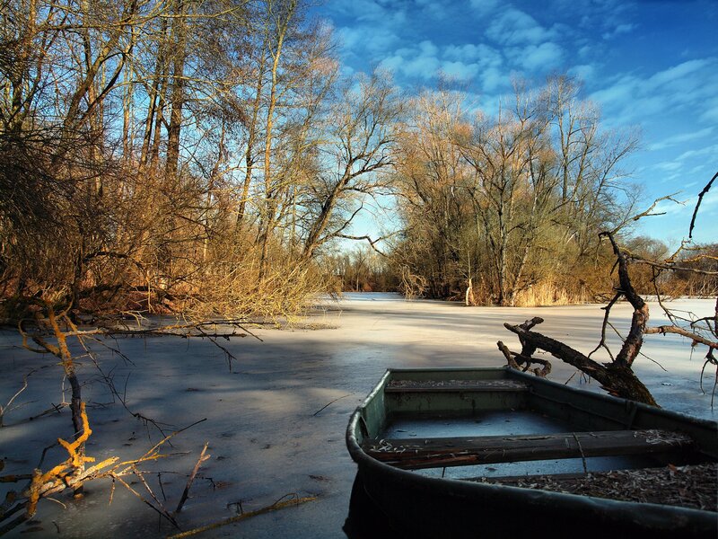 Frozen river with boat