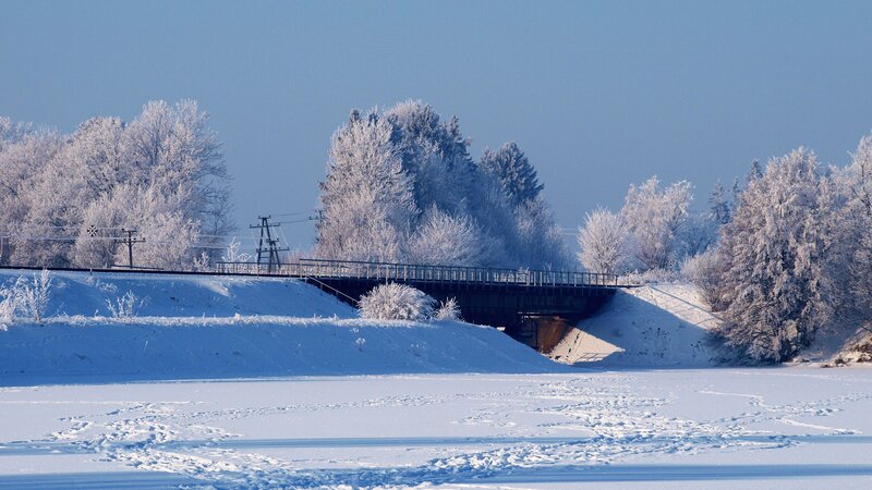 Frozen river with bridge