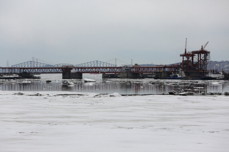 Frozen river with bridge construction