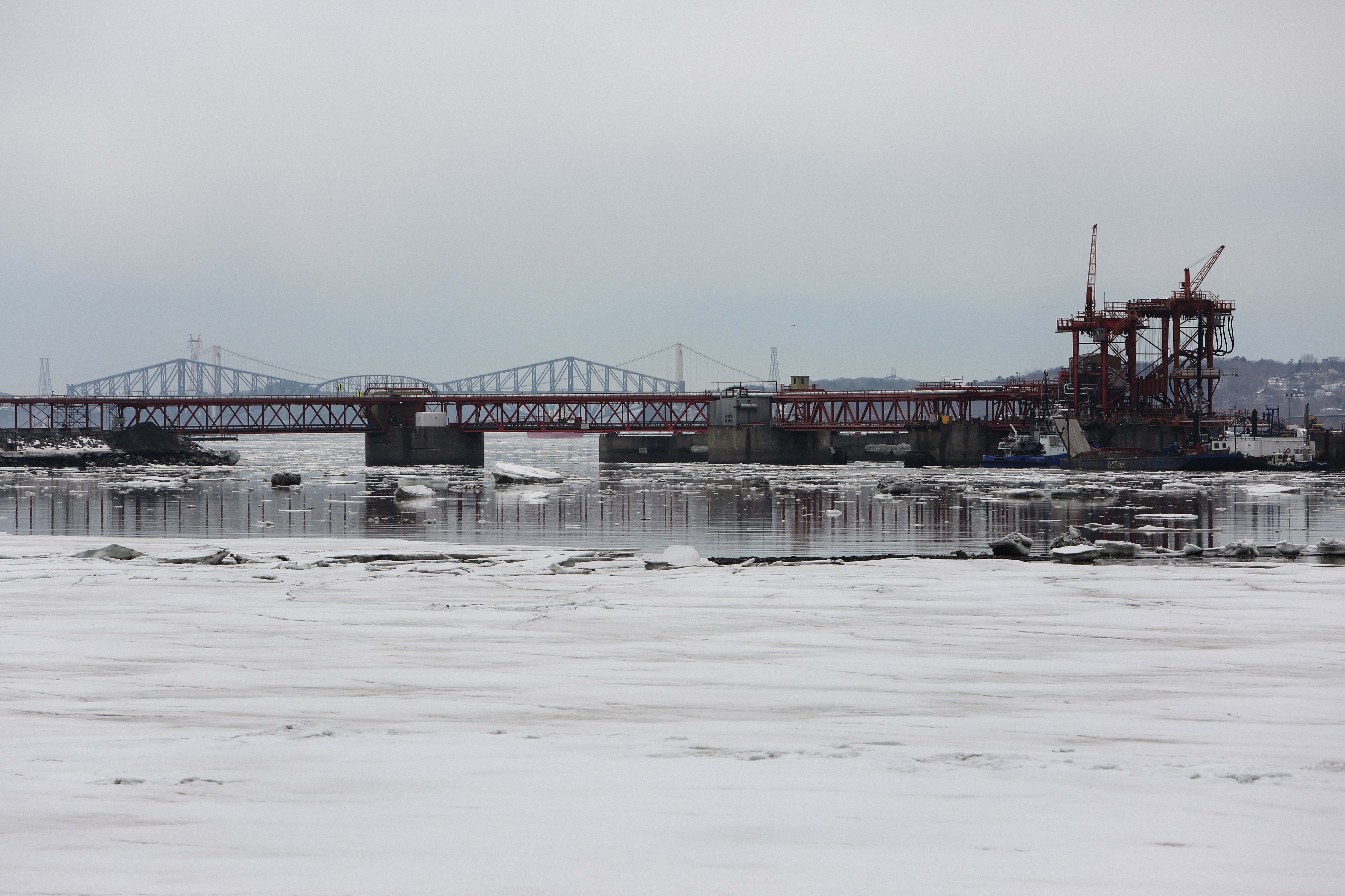 Frozen river with bridge construction