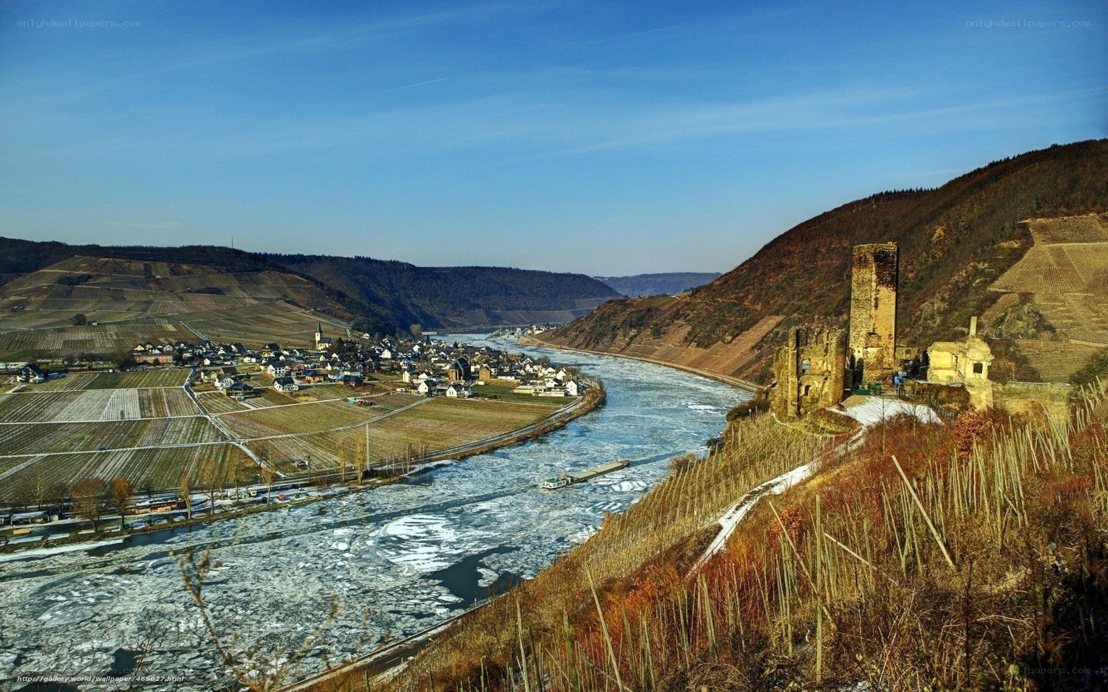 Frozen river with castle ruins