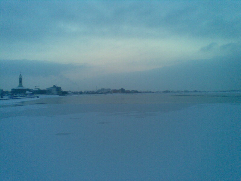 frozen river with city skyline