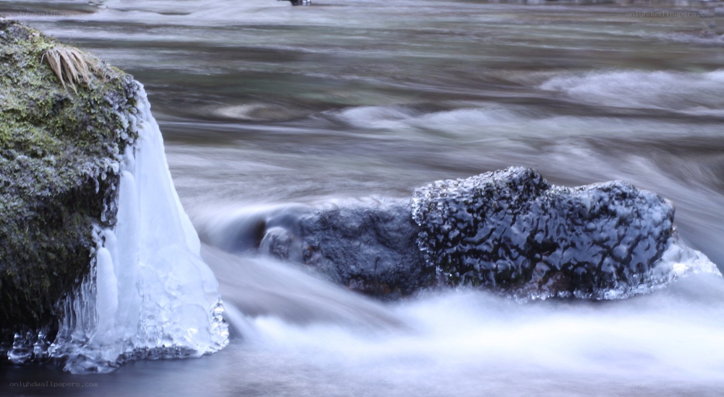 Frozen river with flowing water