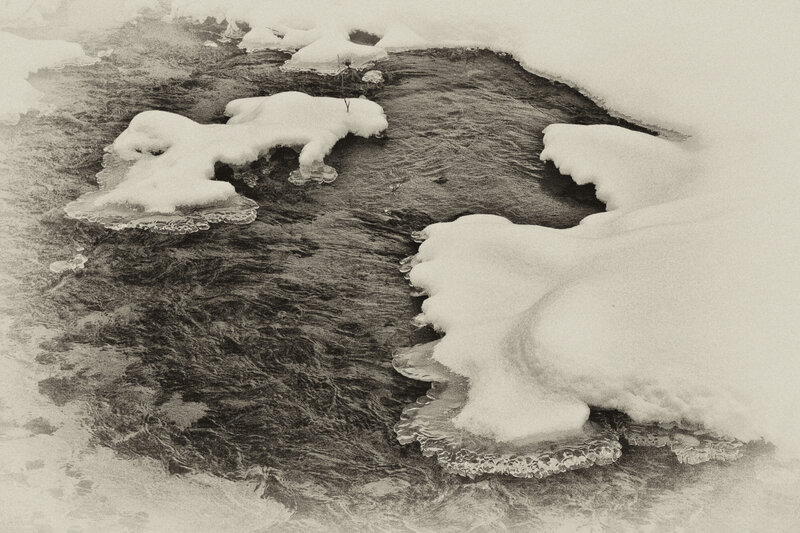 Frozen river with ice patches