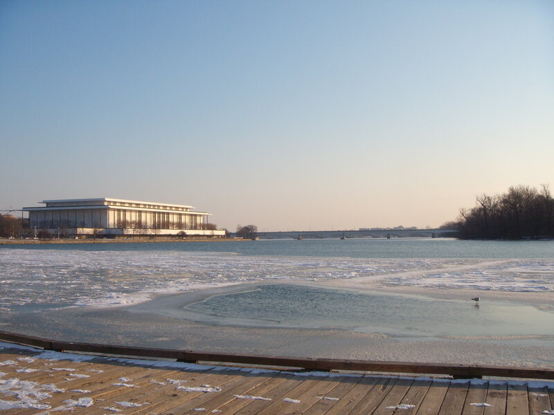 frozen river with modern building