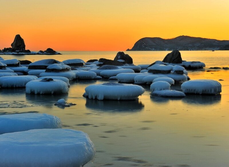 Frozen rocks at sunset