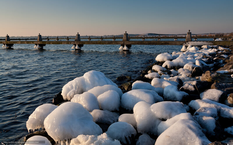 Frozen rocks by a pier