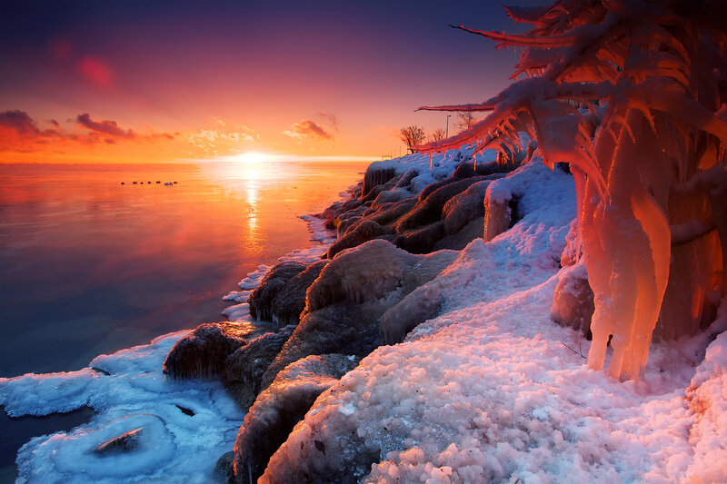Frozen Shoreline at Sunset — Orange, Dramatic, Photograph