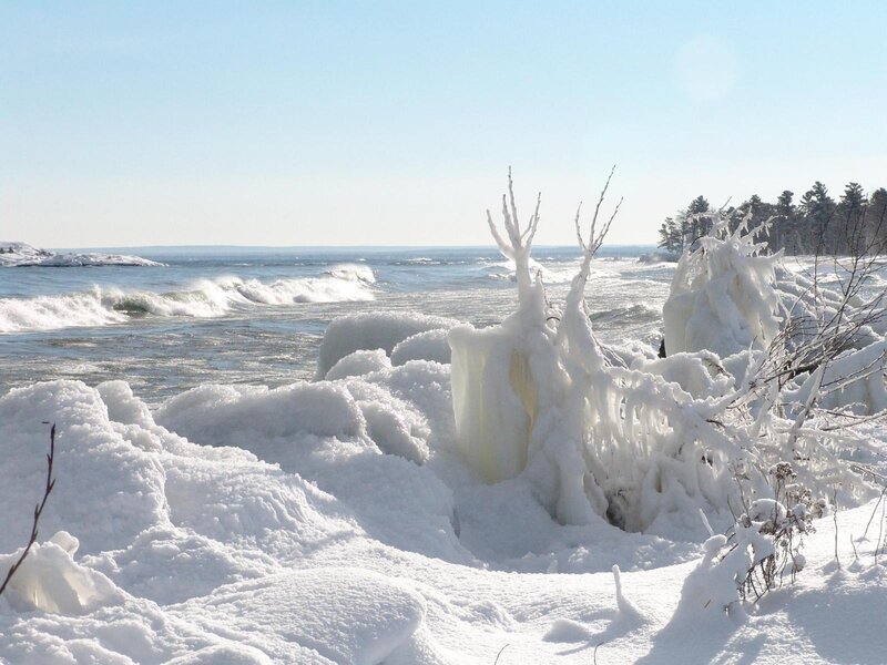 frozen shoreline with icy waves