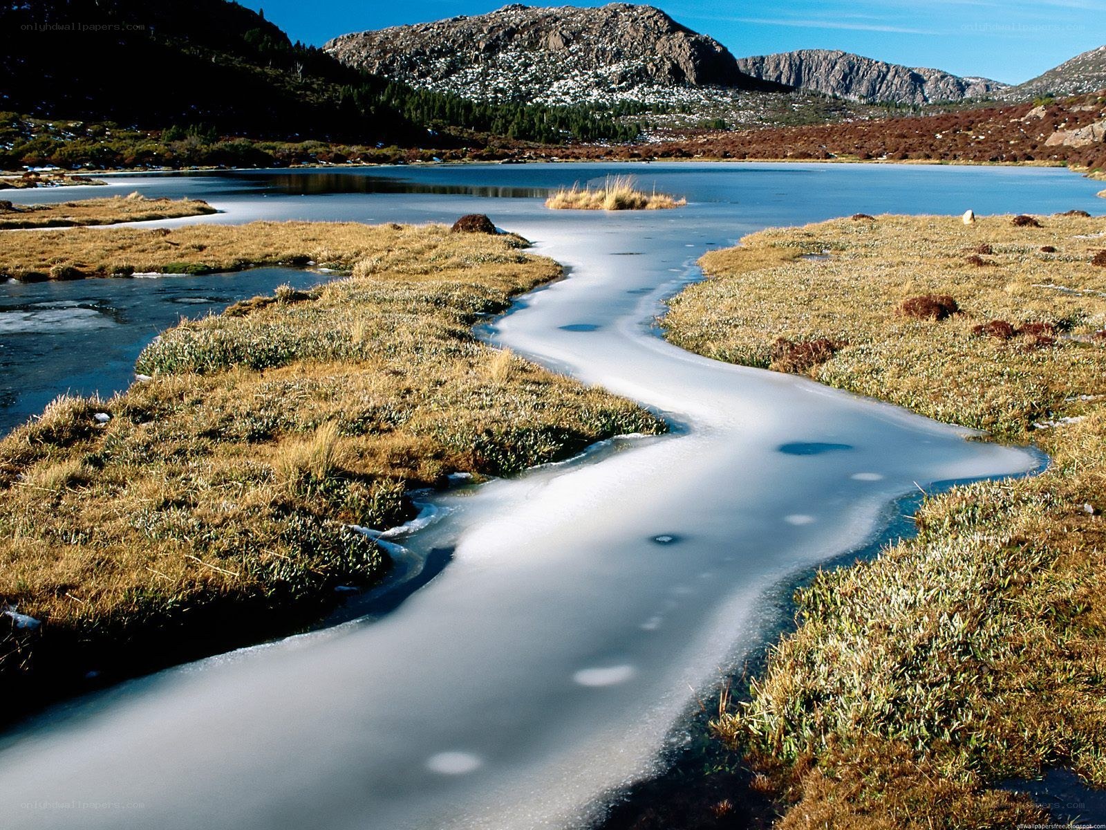 Frozen stream in mountain landscape