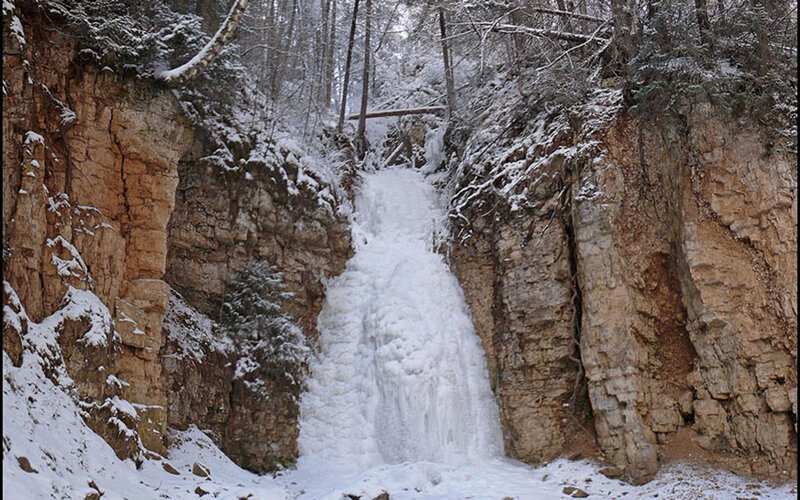 Frozen waterfall in winter forest
