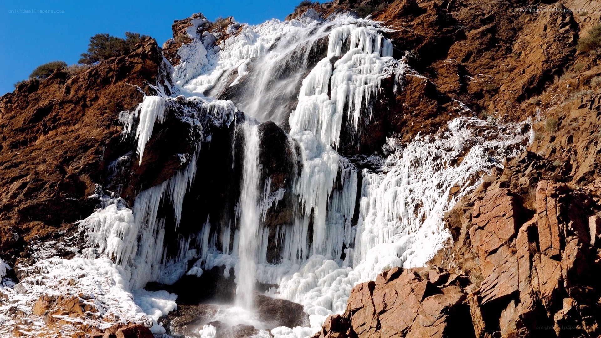 Frozen waterfall on rocky cliff