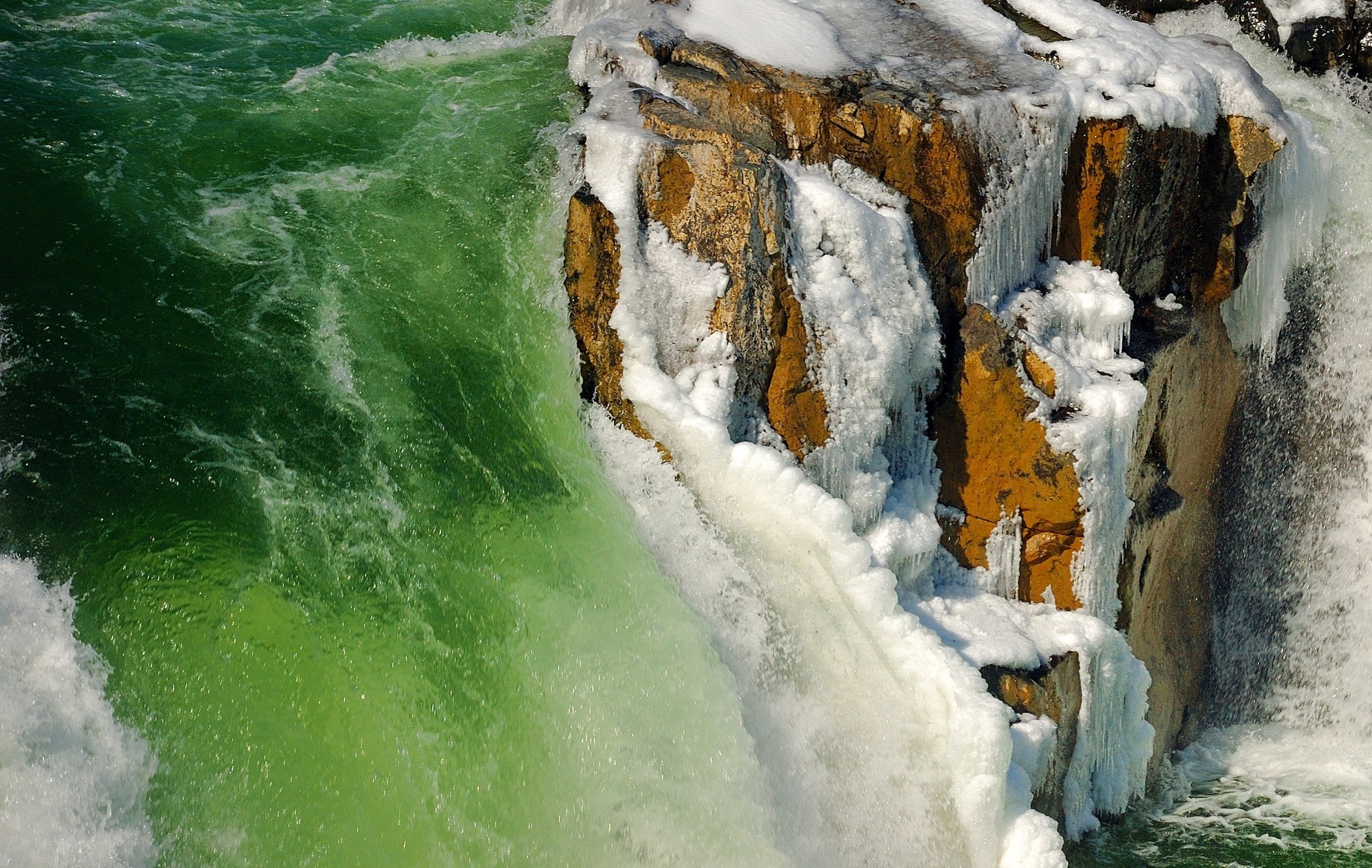 Frozen waterfall with green water