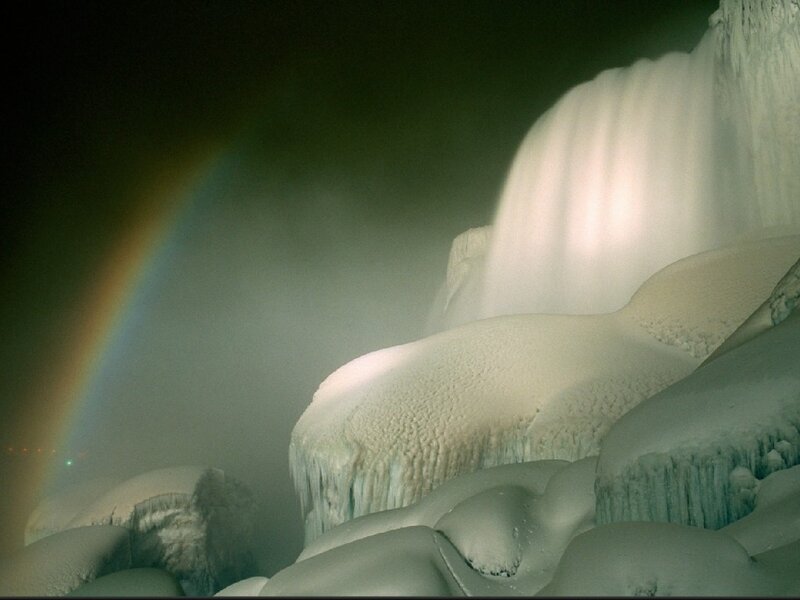 Frozen waterfall with rainbow