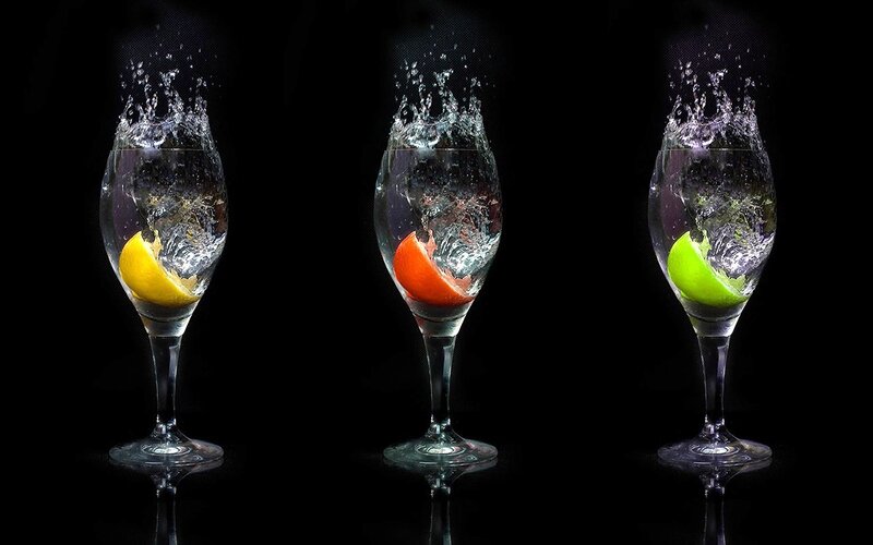 fruit splashing in wine glasses