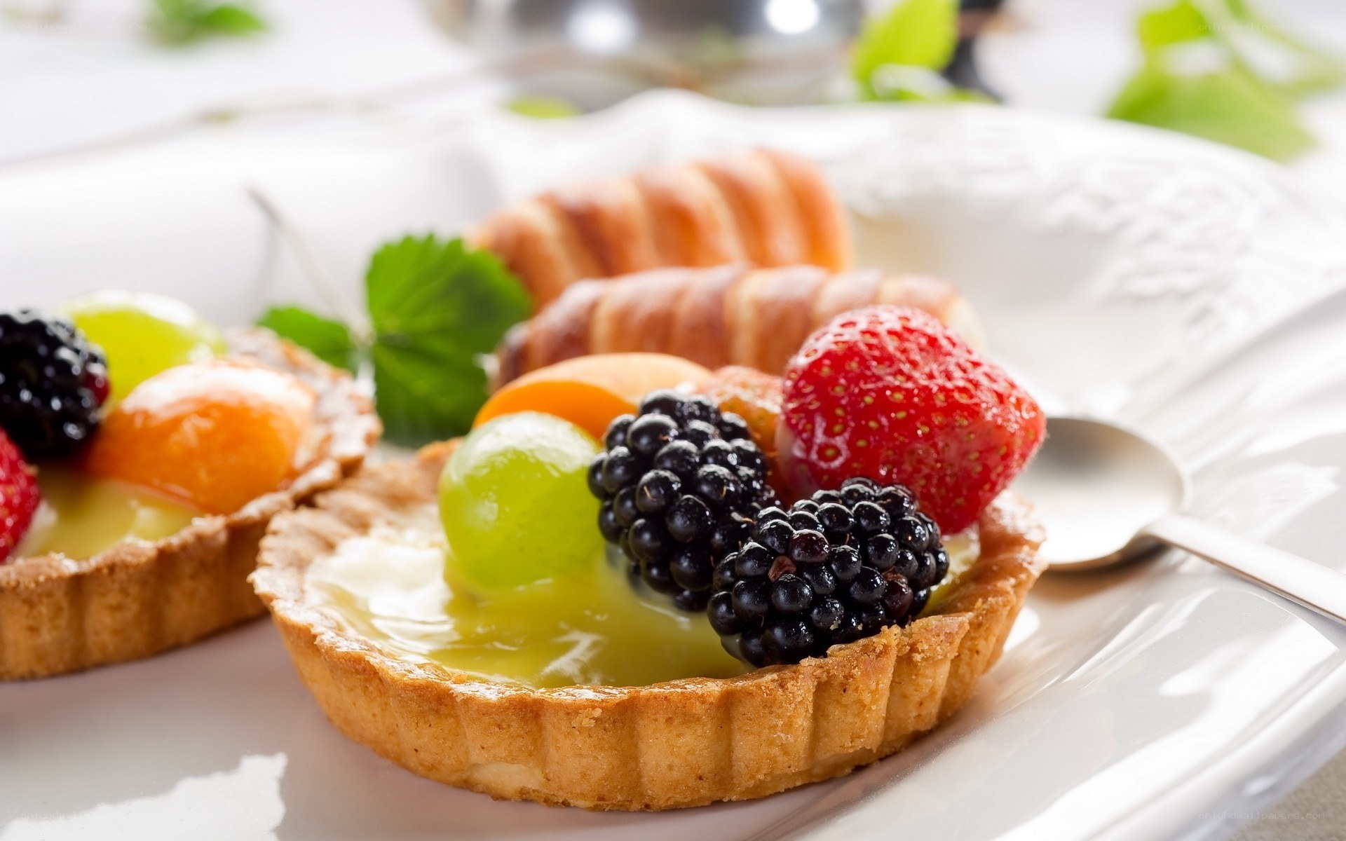 Fruit tarts with berries and grapes