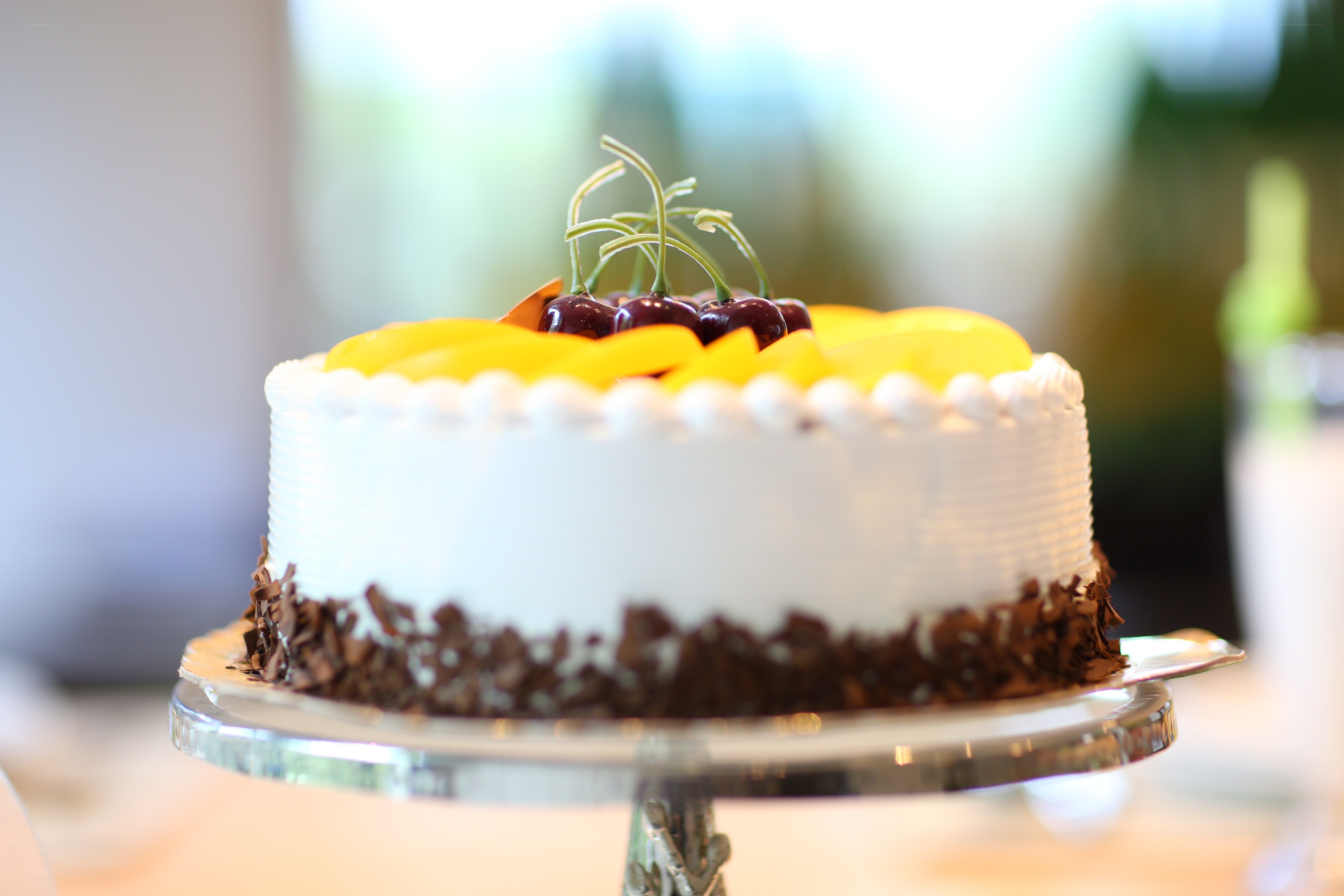 Fruit-topped cake on a stand