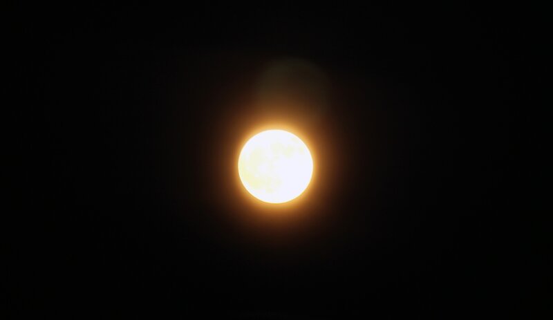 Full moon glowing in night sky