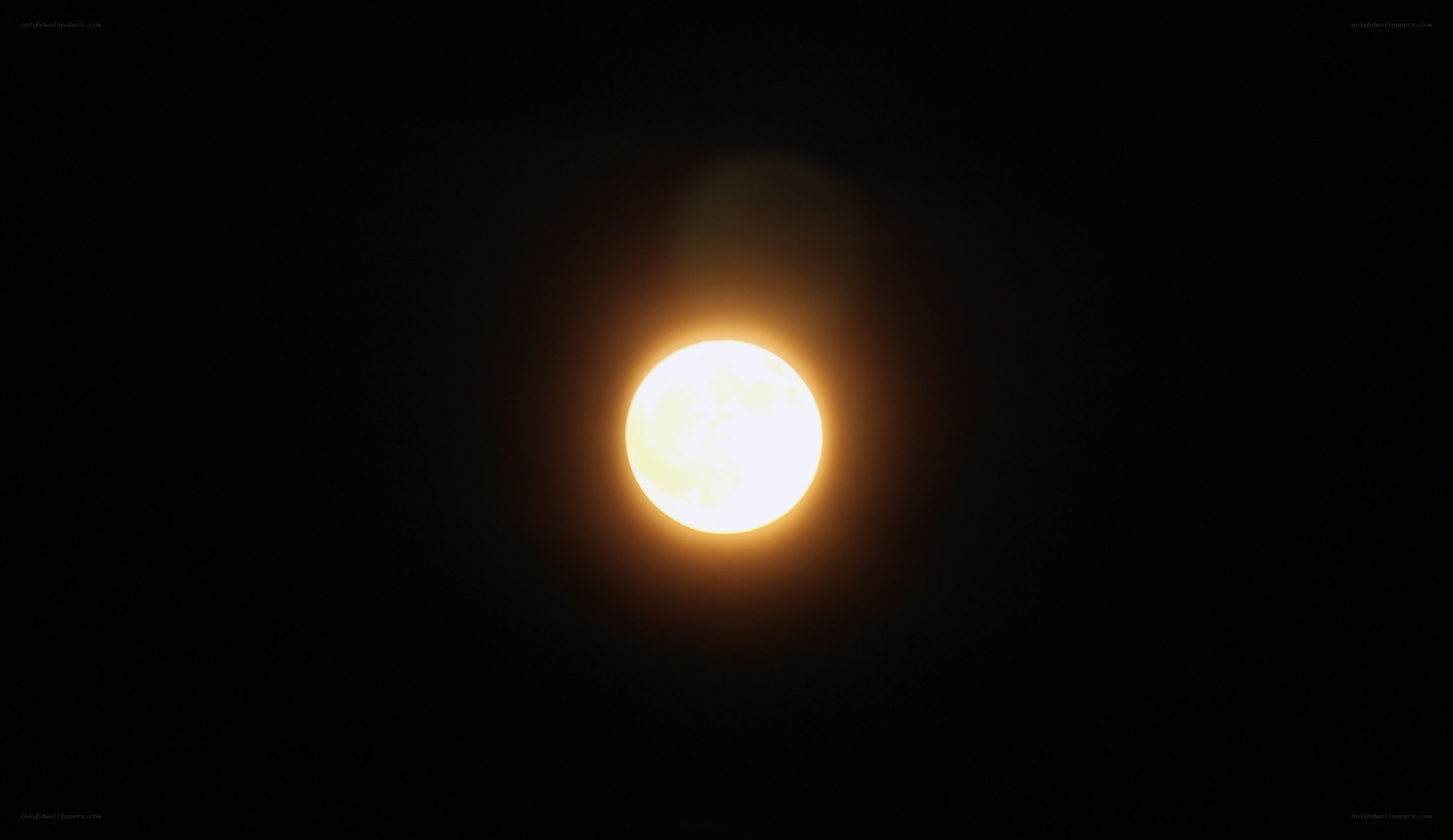 Full moon glowing in night sky