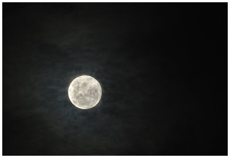 Full moon in cloudy sky