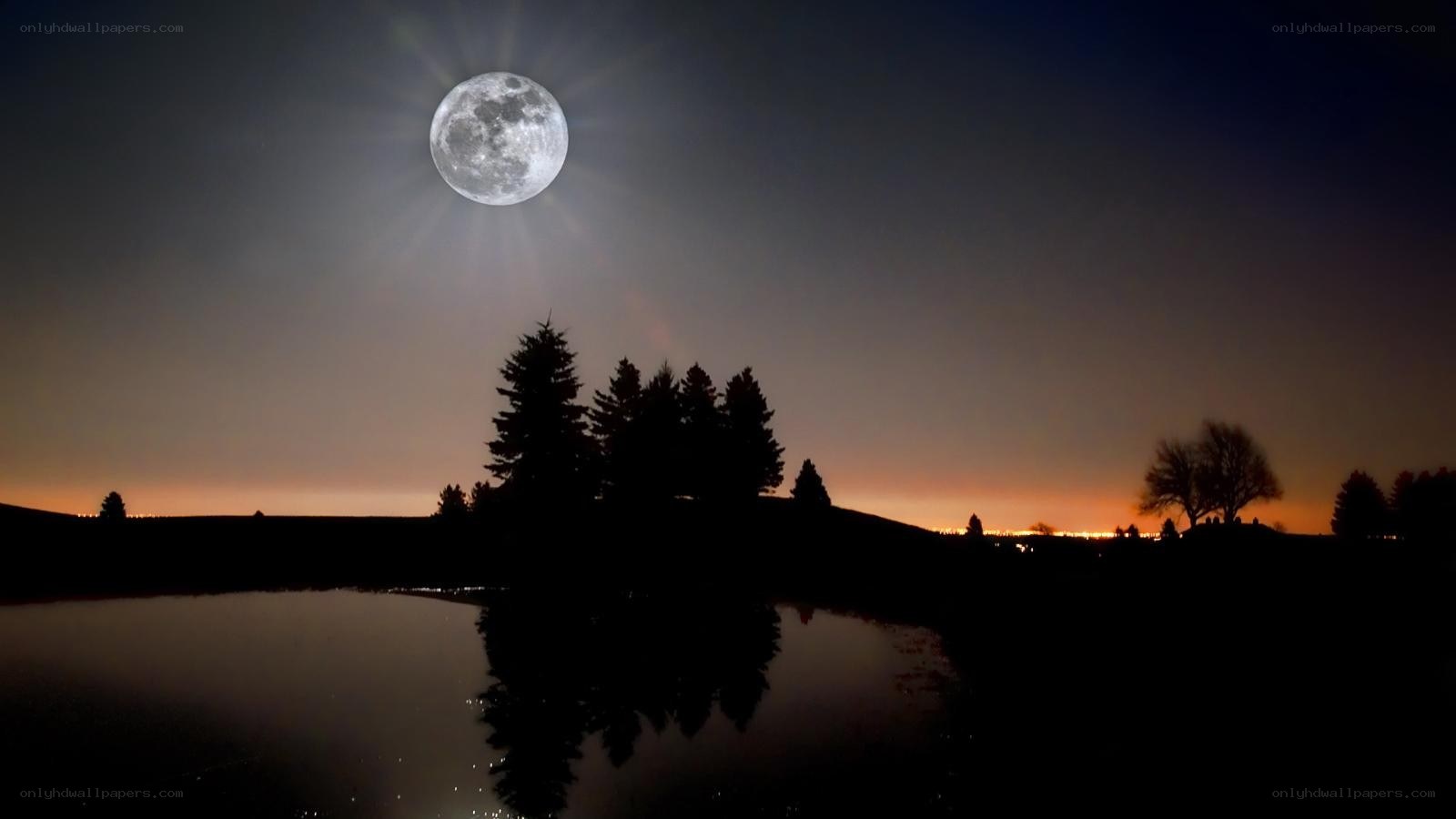 Full moon over a calm lake