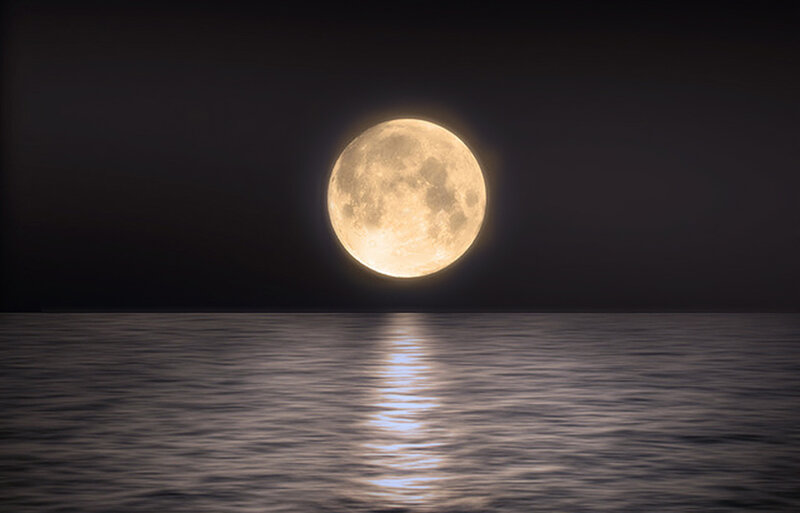 Full moon over calm water