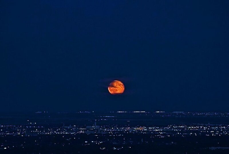 Full moon over cityscape