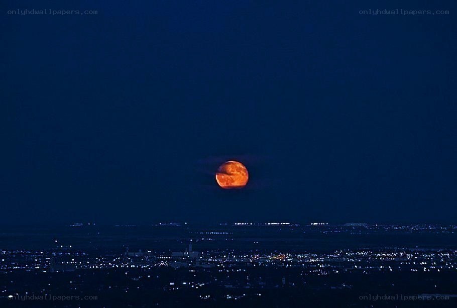 Full moon over cityscape