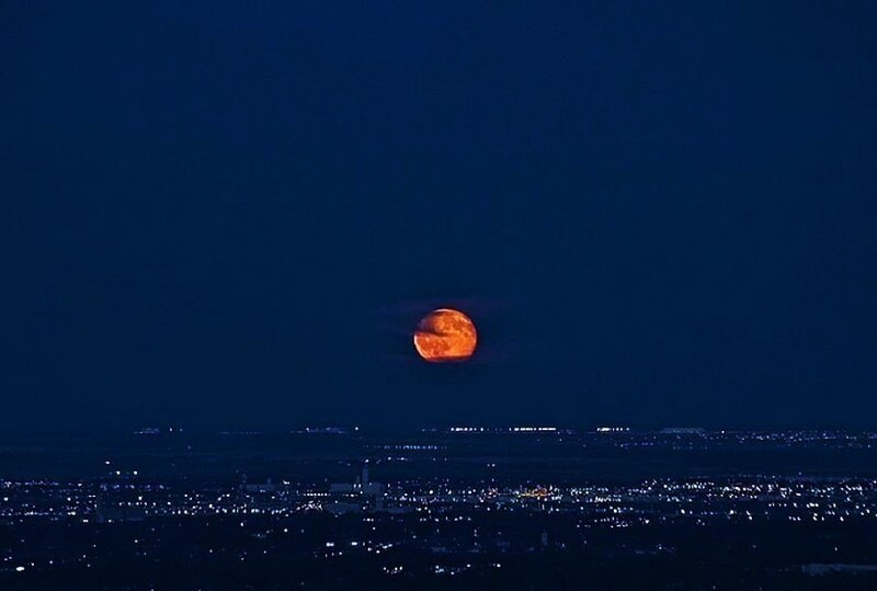 Full moon over cityscape