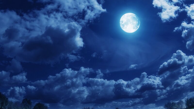 Full moon over cloudy night