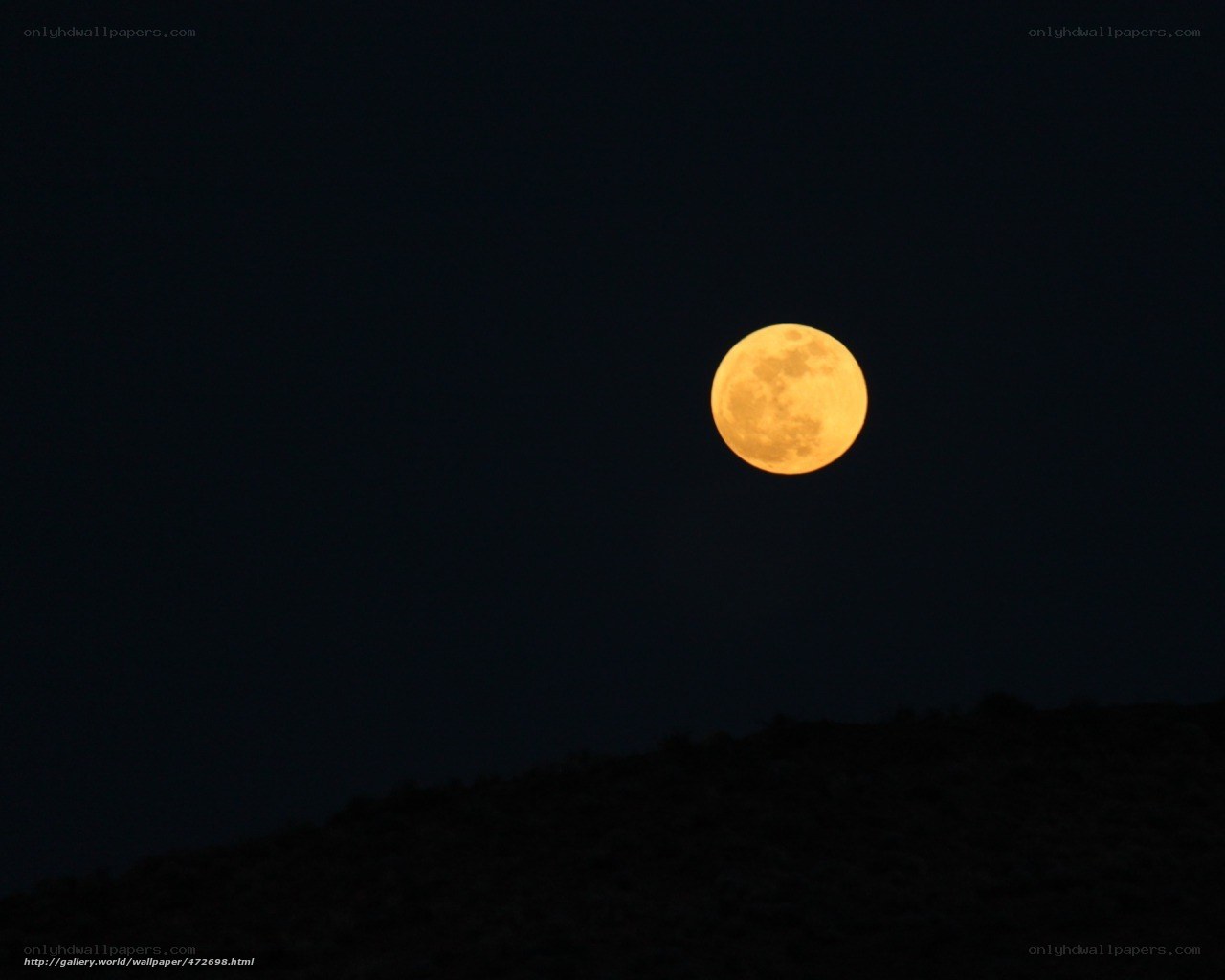 Full moon over dark hills