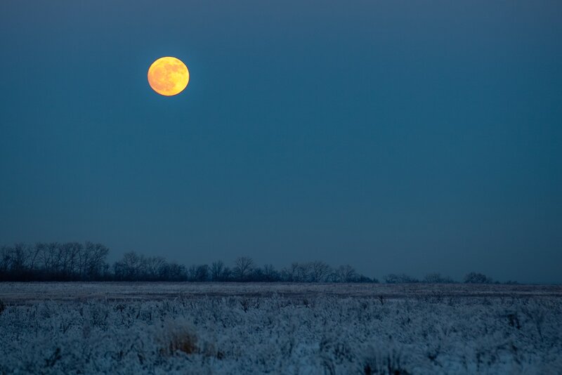 Full moon over frosty field