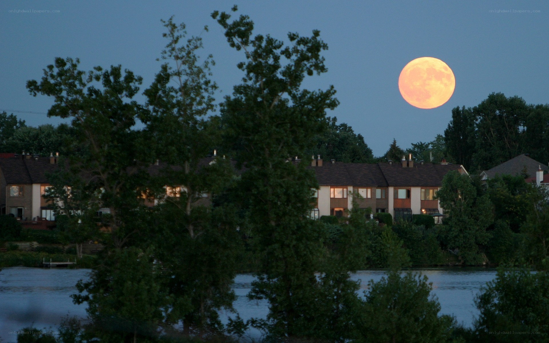 Full moon over lakeside homes