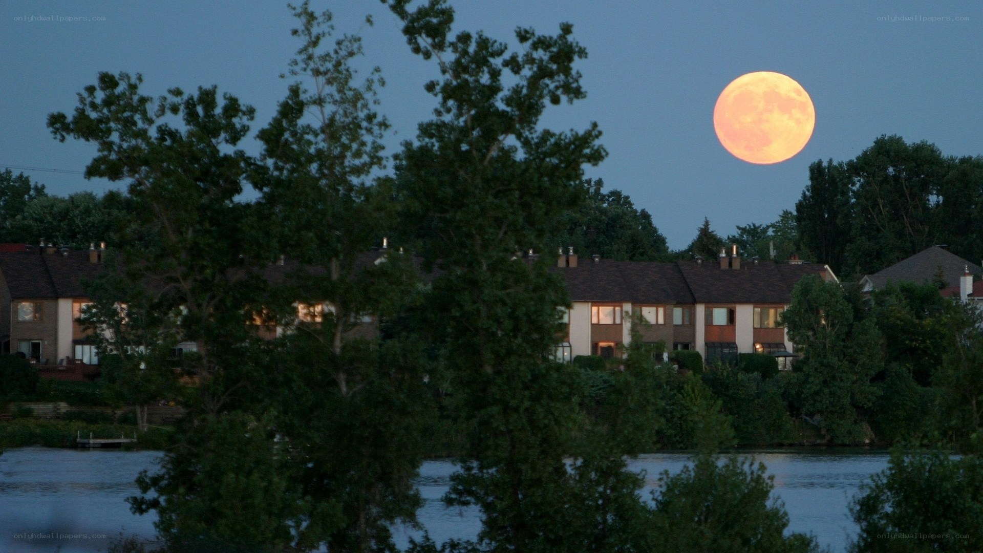 Full moon over lakeside homes