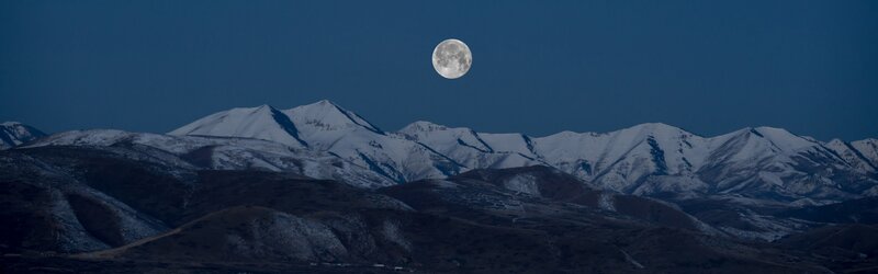 Full Moon over Snow-capped Mountains