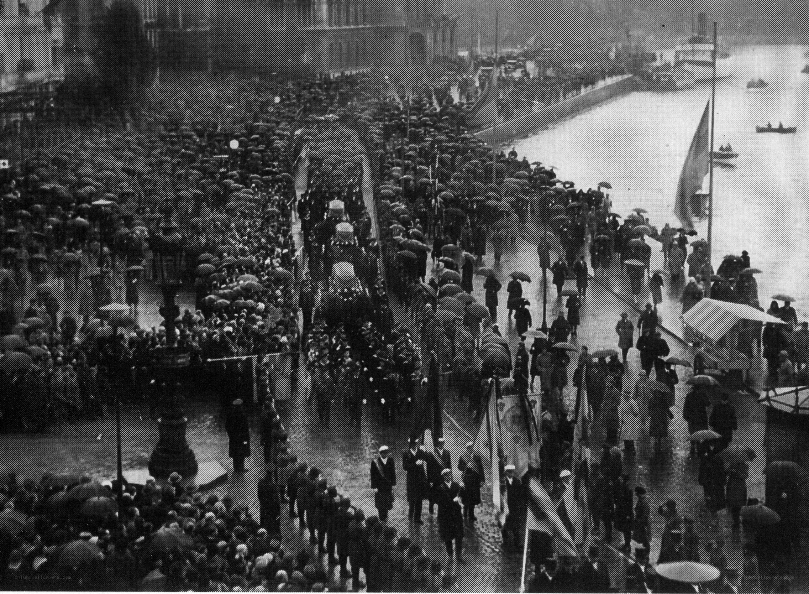 Funeral procession in rainy city