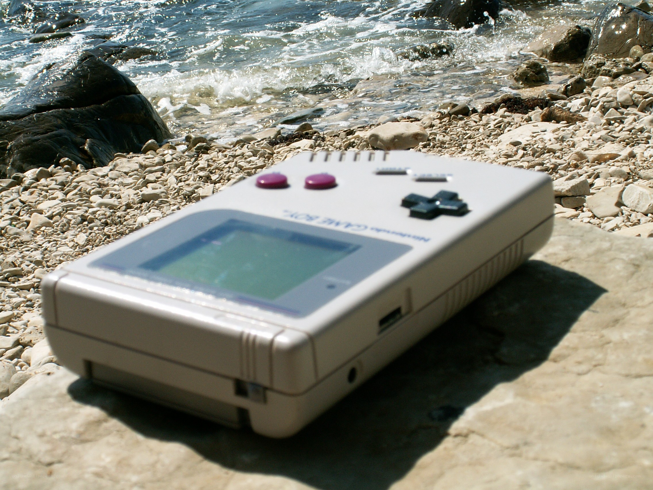 Game Boy on a rocky beach