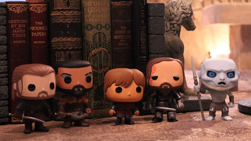 Game of Thrones figures on bookshelf