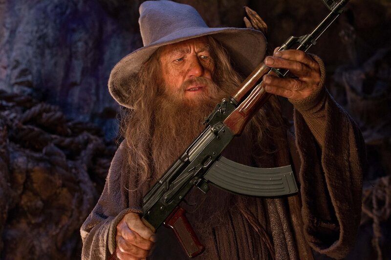 Gandalf Holding Rifle — Brown