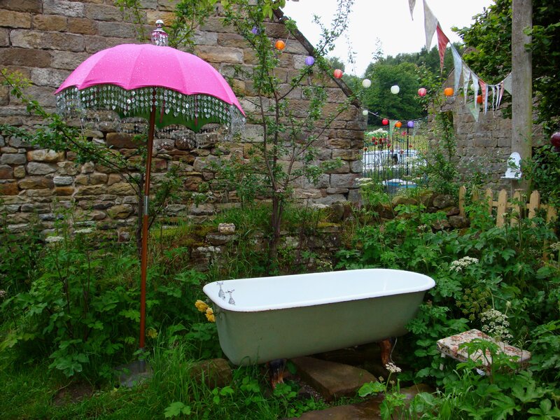 Garden bathtub with pink umbrella