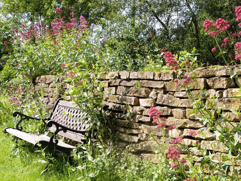 Garden Bench by Stone Wall
