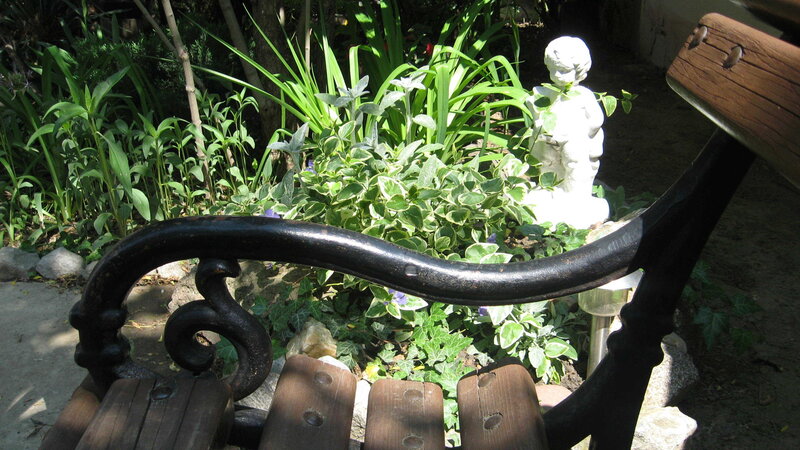 Garden bench with statue