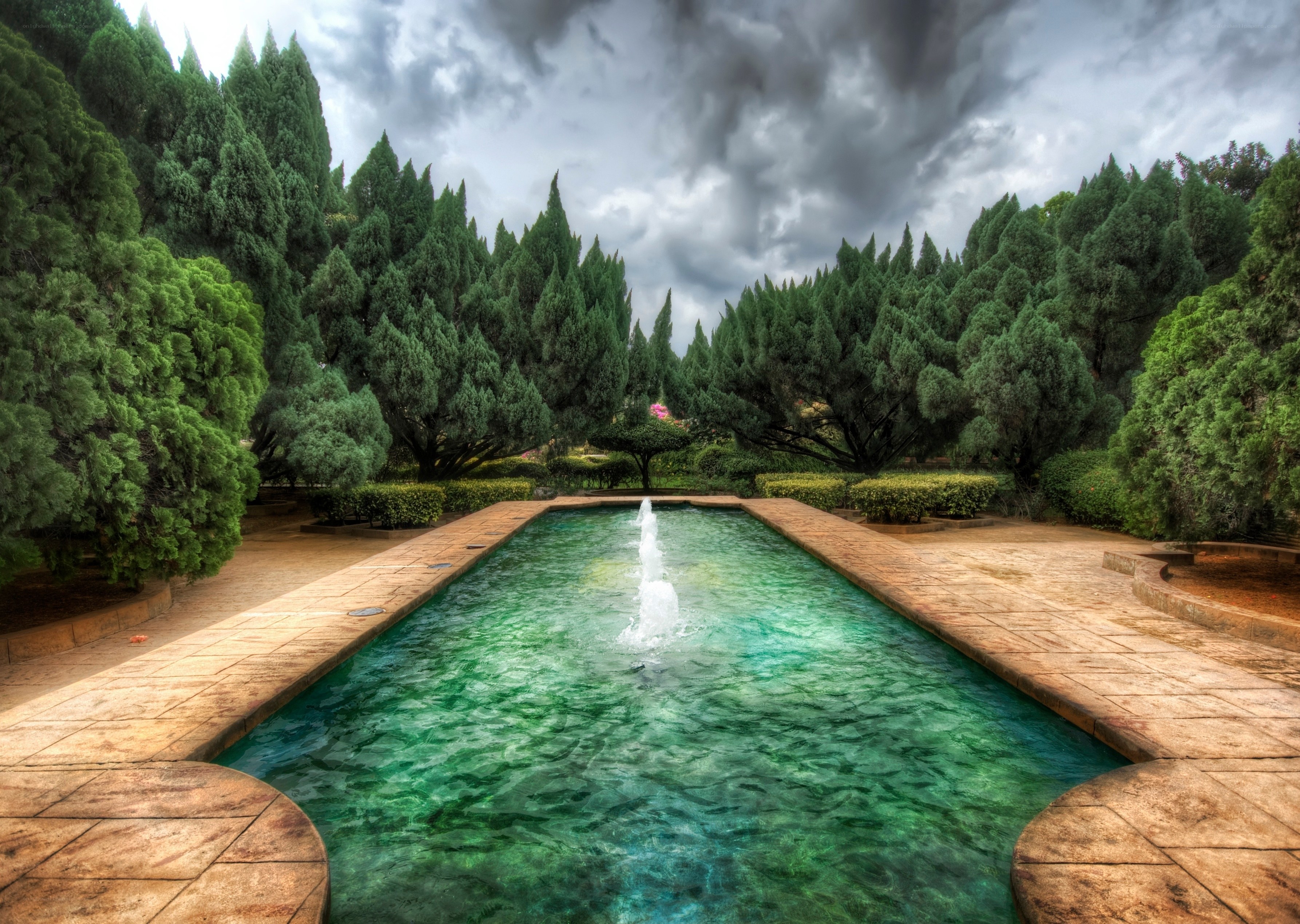 Garden fountain under stormy sky
