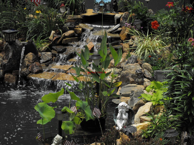 Garden pond with waterfall and decorations