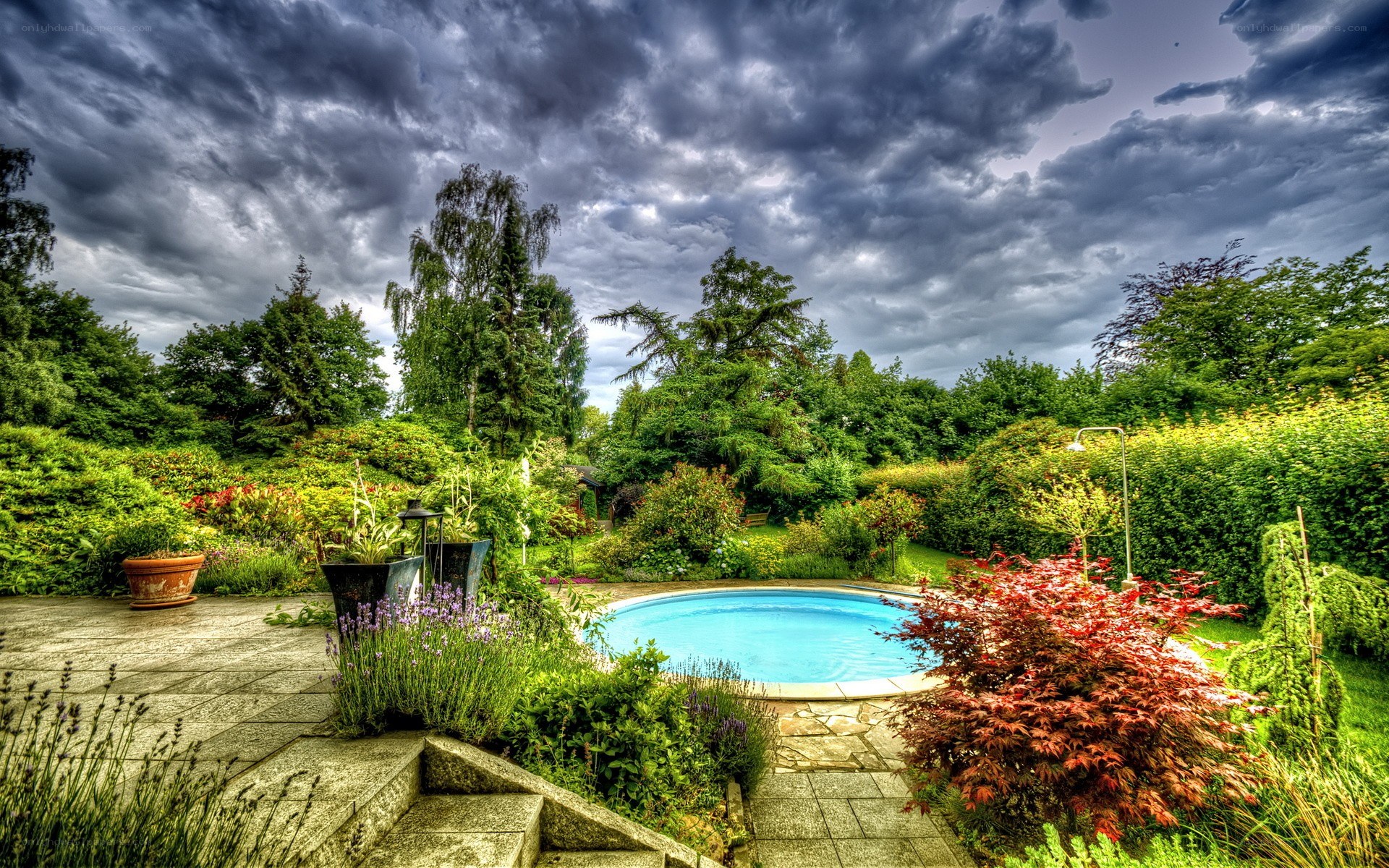Garden pool under stormy sky