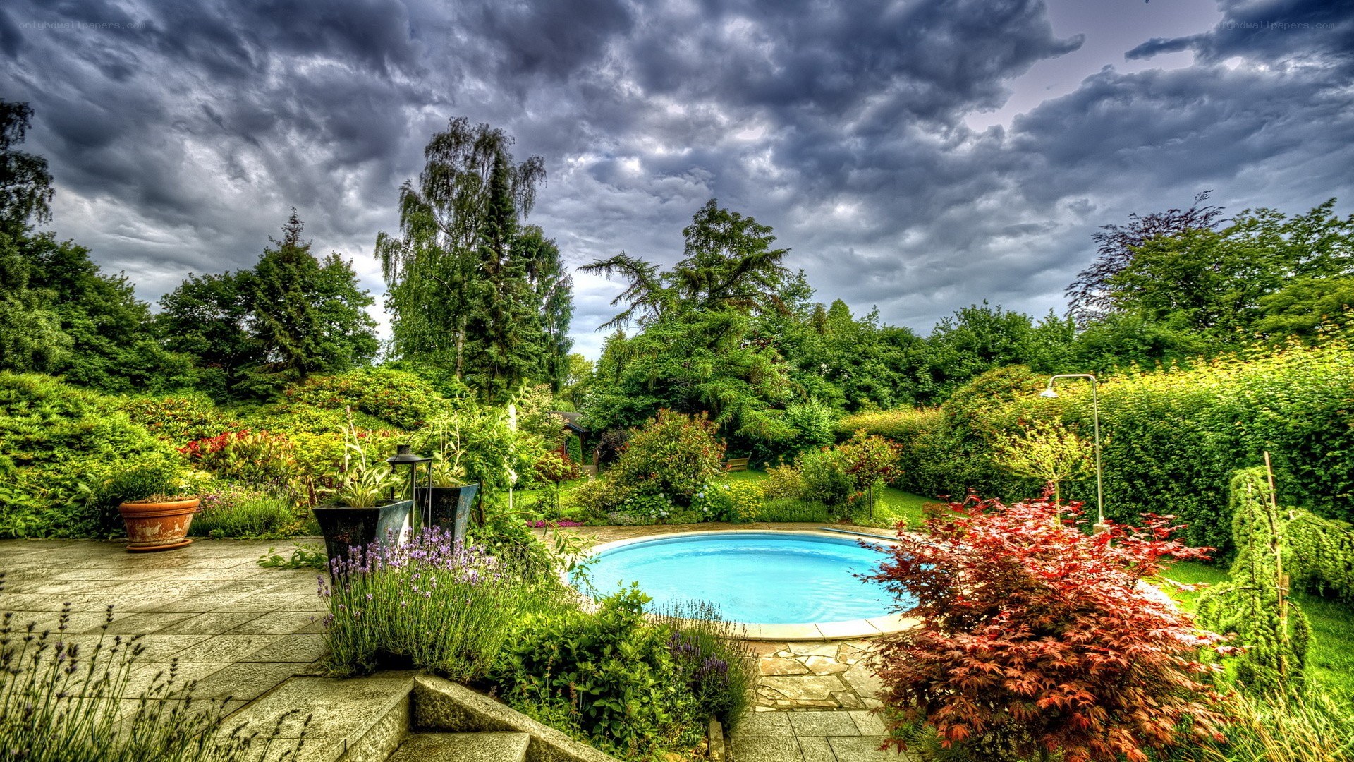 Garden pool under stormy sky