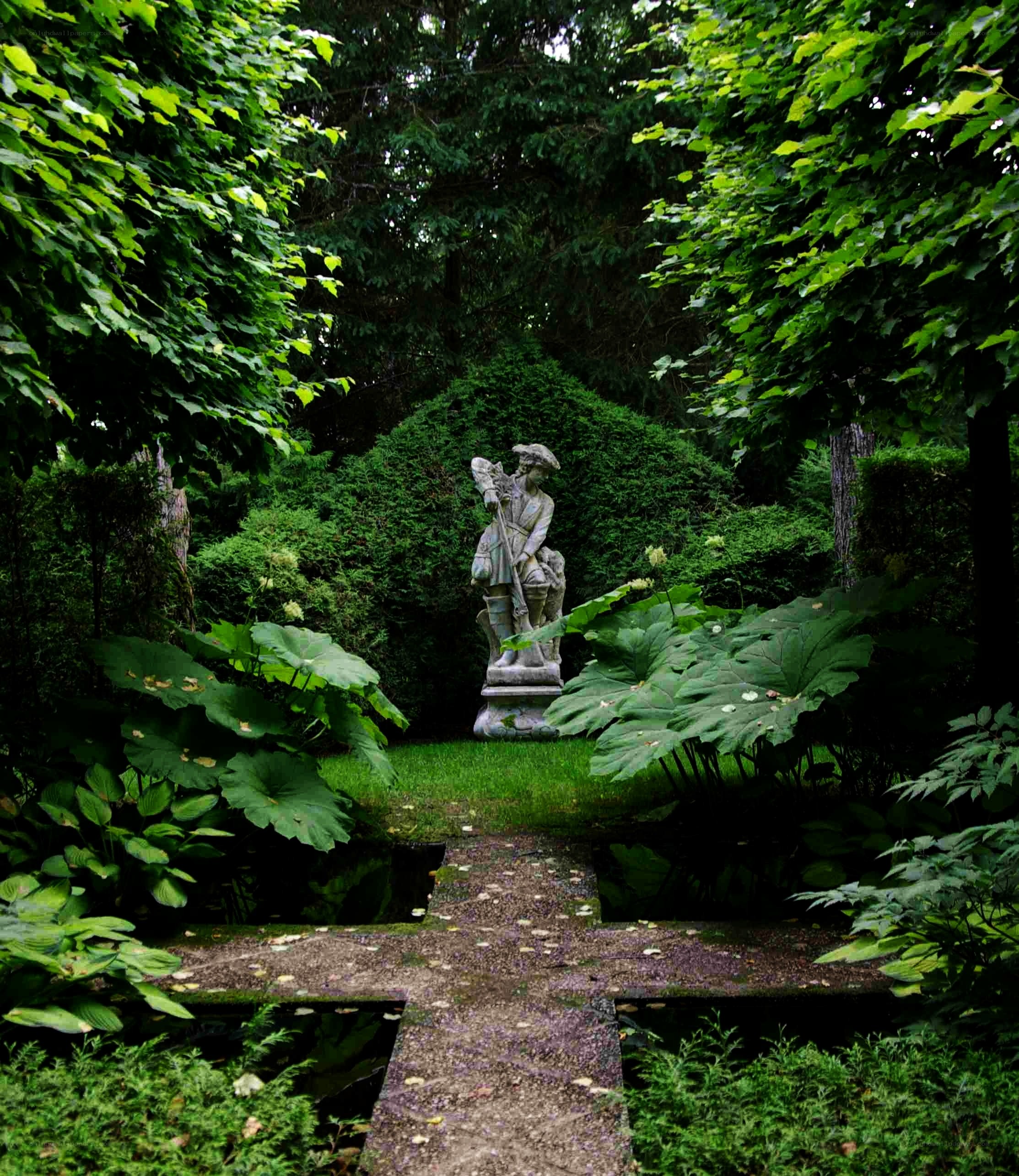 Garden statue in lush greenery