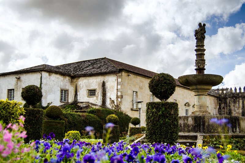Garden with fountain and historic building
