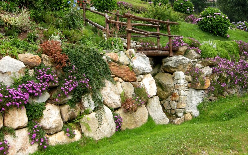 Garden with stone wall and bridge
