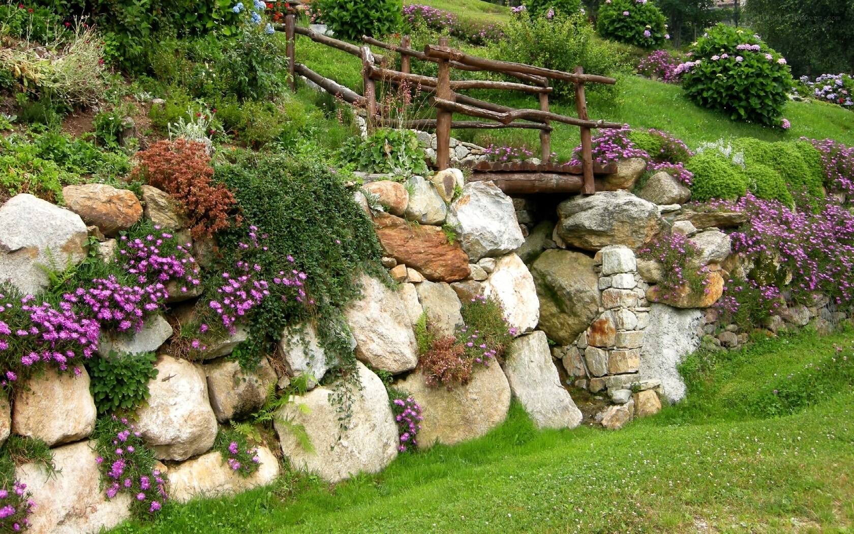 Garden with stone wall and bridge